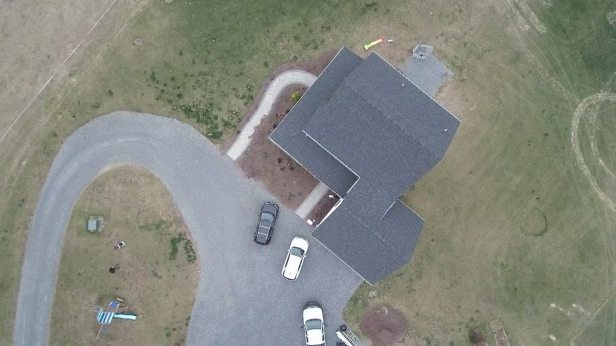 Drone aerial view of the existing rural home and driveway approach