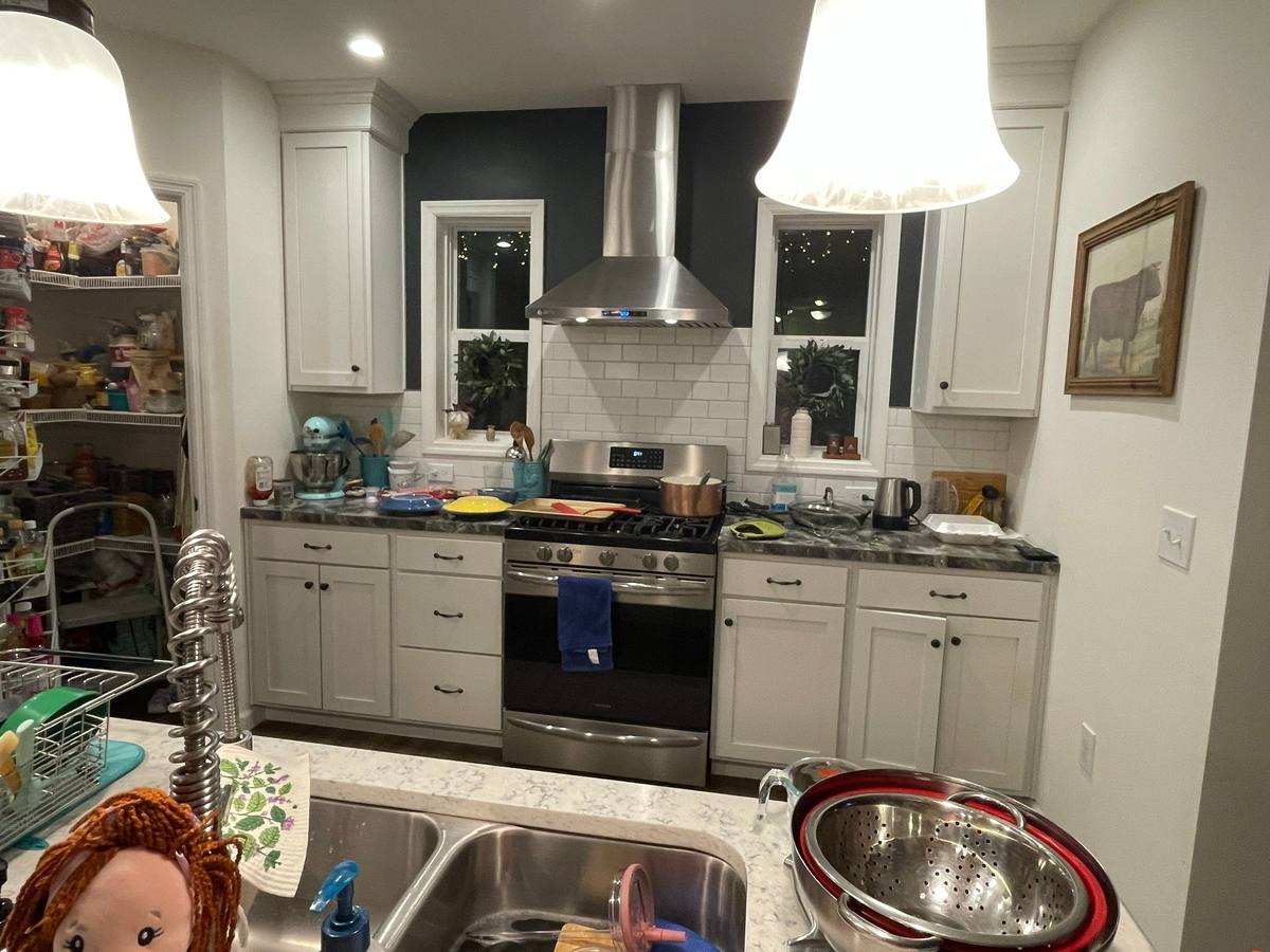 Existing kitchen showing limited work area and storage constraints