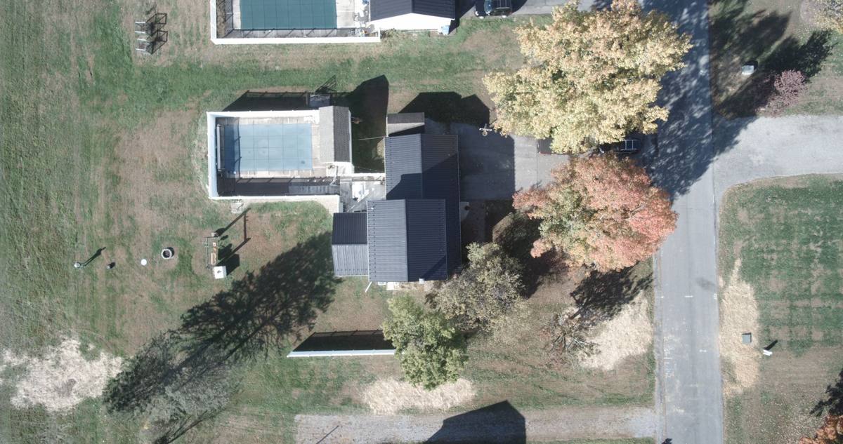 Aerial view of the existing home and site context