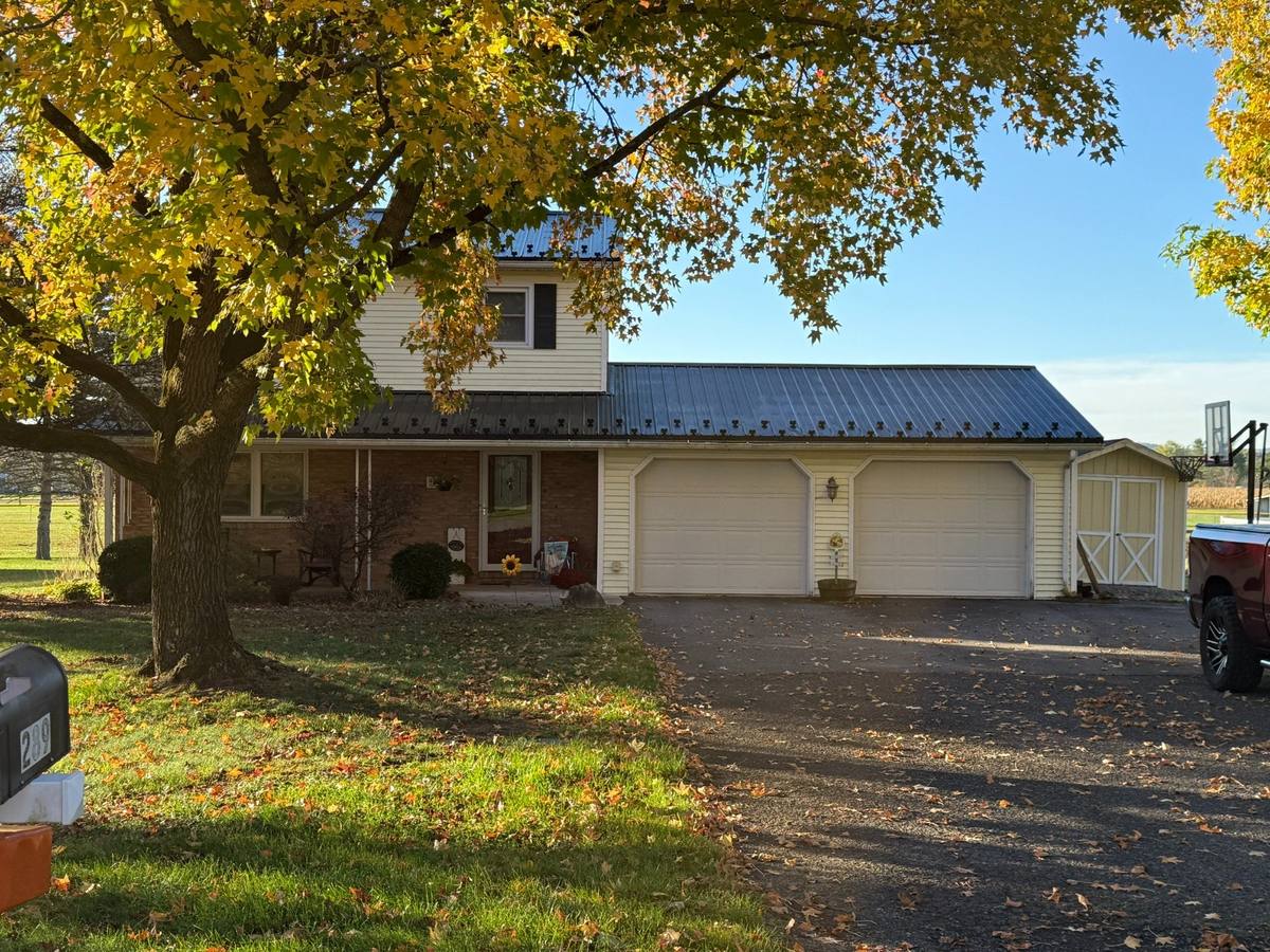Existing front exterior of the home and garage before the primary suite addition design