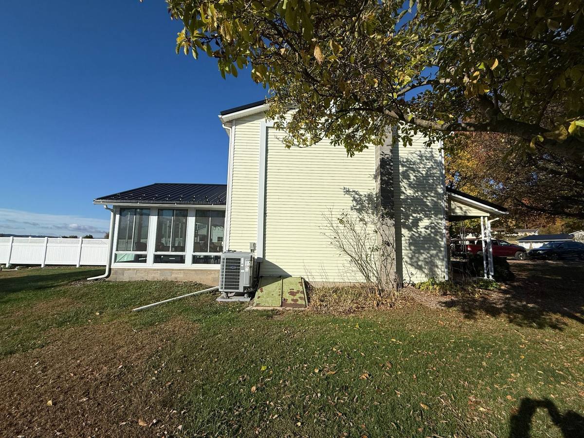 Side view of the existing house showing the area around the garage and enclosed porch