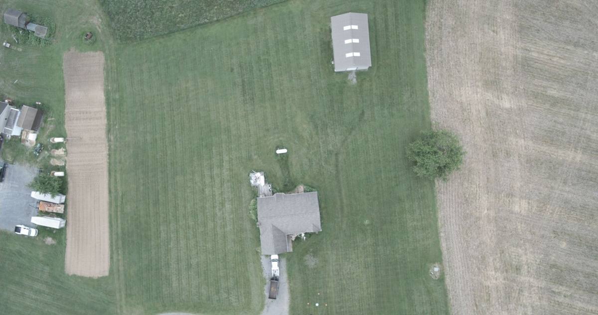 Drone image looking straight down at the existing house and surrounding site